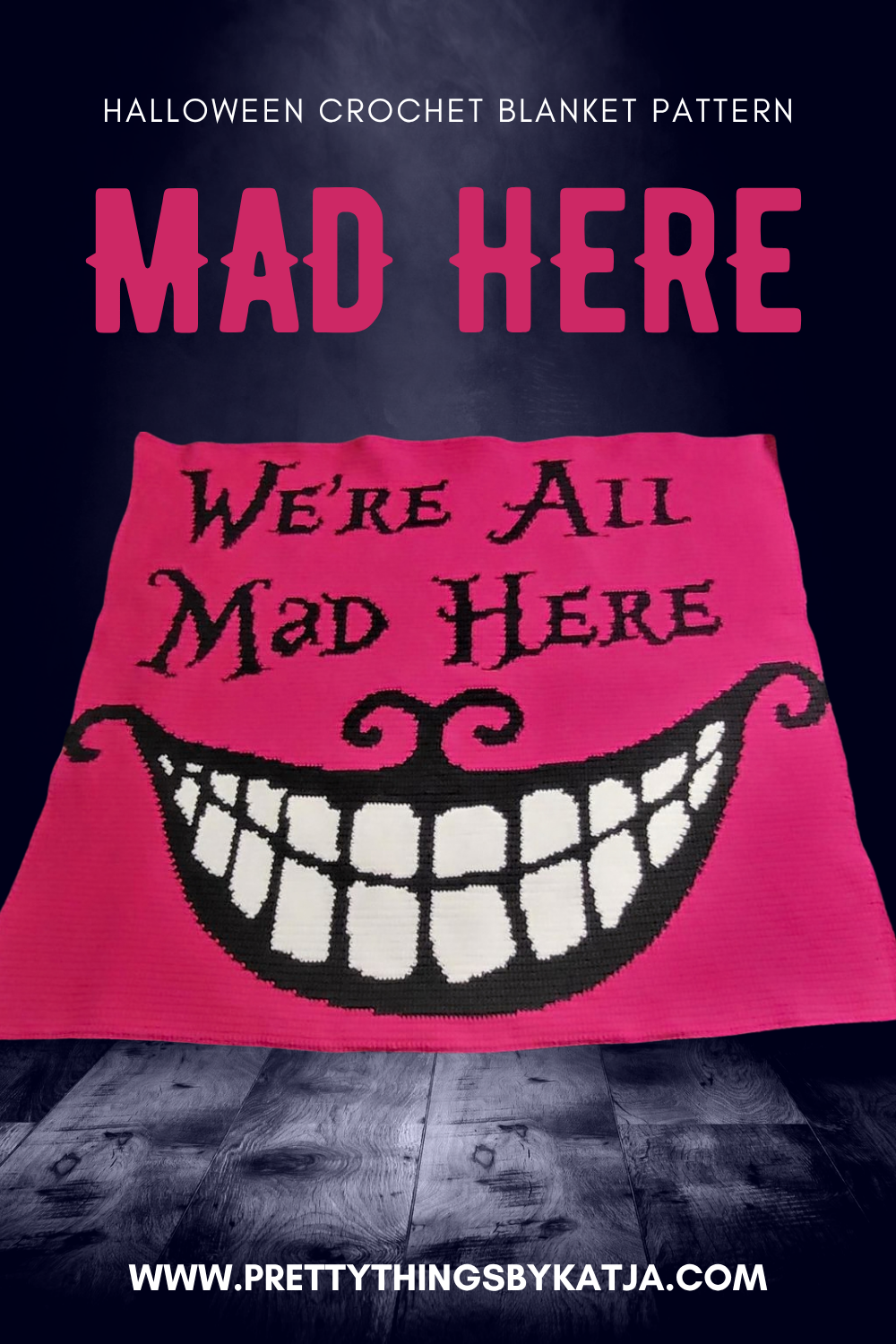 Pink We’re All Mad Here crochet blanket with large black and white grinning face