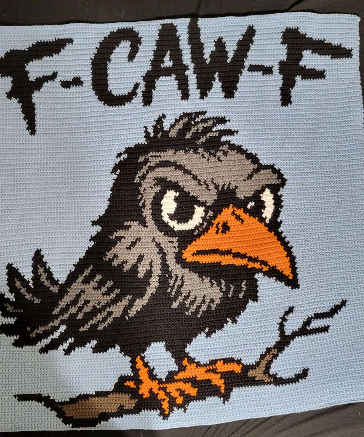 Funny crow crochet blanket with F-Caw-F text made from a Halloween graphghan pattern