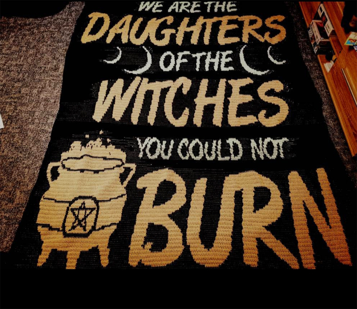 Finished witch crochet blanket with cauldron and We Are the Daughters of the Witches quote