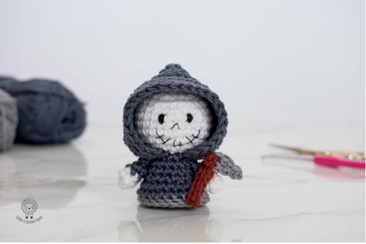 Free Grim Reaper crochet blanket pattern with hooded skeleton and purple Halloween graphghan background Cute Grim Reaper amigurumi free crochet pattern with black hood and crochet scythe